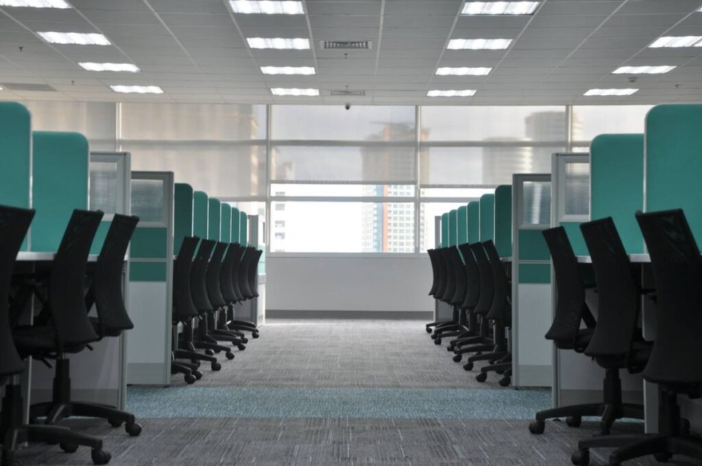 Empty open-plan office with rows of desks and chairs